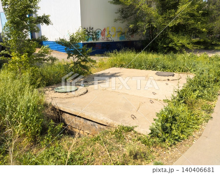 Urban concrete structure with graffiti in overgrown industrial area Urban concrete structure with graffiti in overgrown industrial area 140406681