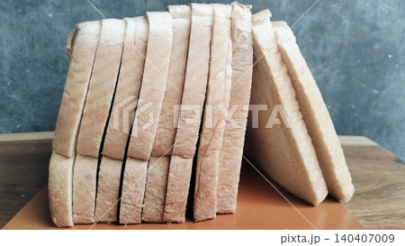 Sliced white bread on a rustic wooden table background Sliced white bread on a rustic wooden table background 140407009