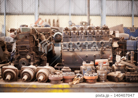 Recycle, scrap metal and rust in workshop at junkyard for sorting, garbage and at trash at landfill site. Steel, iron factory and engine parts on table in plant with mechanic machine at waste dump. 140407047