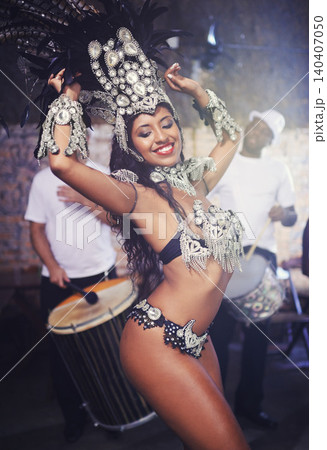 Culture, samba and woman at carnival with costume for celebration, music and happy band performance in Brazil. Dance, party and girl in street festival, parade or show in Rio de Janeiro with smile. Culture, samba and woman at carnival with costume for celebration, music and happy band performance in Brazil. Dance, party and girl in street festival, parade or show in Rio de Janeiro with smile. 140407050