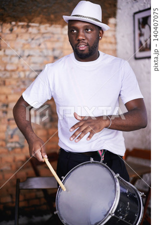 Performance, drum or carnival with a black man playing an instrument in a festival in Rio de Janeiro. Brazil, rhythm or party with a musician, performer or artist banging to create a beat in show Performance, drum or carnival with a black man playing an instrument in a festival in Rio de Janeiro. Brazil, rhythm or party with a musician, performer or artist banging to create a beat in show 140407075