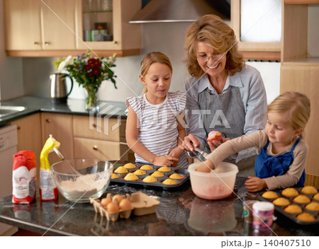 Grandmother, children and baking cupcakes or teaching with icing decorations or learning creativity, bonding or teamwork. Woman, siblings and sweet treats or helping with ingredients, snack or recipe 140407510