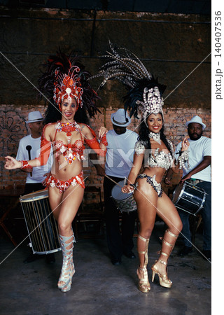 Portrait, samba and women at carnival in costume for celebration, music culture and happy band in Brazil. Dance, party and girl friends together at festival, parade or stage show in Rio de Janeiro 140407536