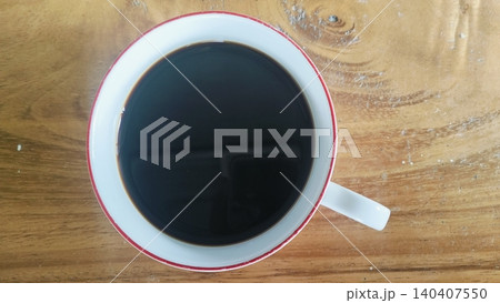 Black Coffee in Ceramic Floral Cup on Wooden Table Black Coffee in Ceramic Floral Cup on Wooden Table 140407550