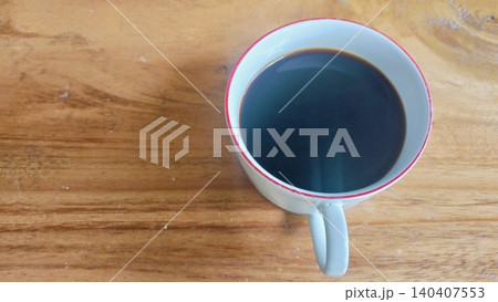 Black Coffee in Ceramic Floral Cup on Wooden Table Black Coffee in Ceramic Floral Cup on Wooden Table 140407553