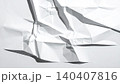 Torn and crumpled white paper with dramatic shadows on bright background 140407816