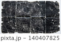 Heavily weathered dark paper with deep fold lines and worn texture 140407825