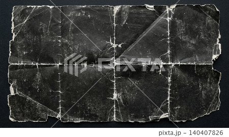 Heavily weathered dark paper with deep fold lines and worn texture Heavily weathered dark paper with deep fold lines and worn texture 140407826