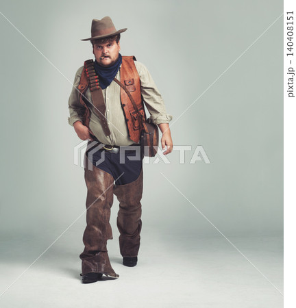Portrait, serious and criminal cowboy in studio mockup, outlaw and wild west character with pistol. Overweight texas man, bandit face or gun belt for fighting, western or cigar by white background Portrait, serious and criminal cowboy in studio mockup, outlaw and wild west character with pistol. Overweight texas man, bandit face or gun belt for fighting, western or cigar by white background 140408151