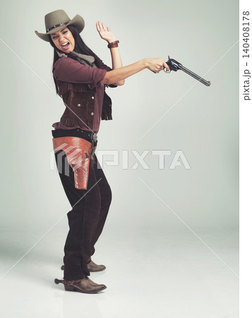 Cowgirl, woman and shooting gun, pistol or weapon in studio with costume isolated on white background mockup. Western, criminal and female person with revolver, scared or screaming in fear in Texas Cowgirl, woman and shooting gun, pistol or weapon in studio with costume isolated on white background mockup. Western, criminal and female person with revolver, scared or screaming in fear in Texas 140408178