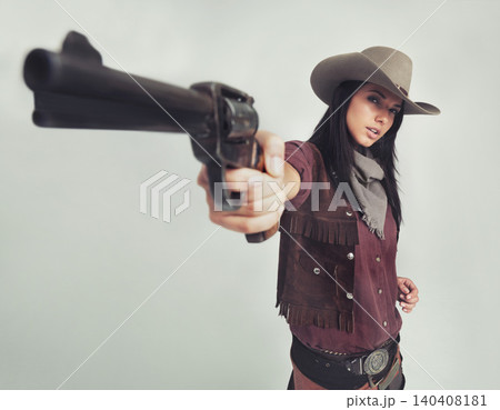 Cowgirl, portrait and gun pointing or western costume with confidence on white background, weapon or mockup space. Female person, face and revolver in studio or old west Texas, accessories or bandit Cowgirl, portrait and gun pointing or western costume with confidence on white background, weapon or mockup space. Female person, face and revolver in studio or old west Texas, accessories or bandit 140408181