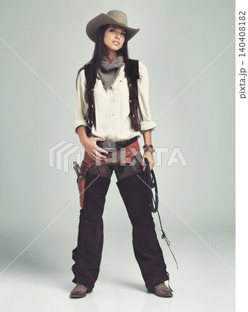 Woman, cowgirl and outfit in studio, portrait and costume for western casting with rope or whip. Female person, cowboy hat and clothes from Texas, white background and dress up for audition or ad Woman, cowgirl and outfit in studio, portrait and costume for western casting with rope or whip. Female person, cowboy hat and clothes from Texas, white background and dress up for audition or ad 140408182