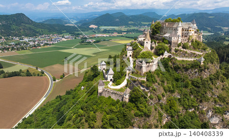 Cinematic drone footage capturing Hochosterwitz Castle on hilltop, fortified walls, dramatic cliffs, summer colors, sweeping aerial movement, historical landmark atmosphere Cinematic drone footage capturing Hochosterwitz Castle on hilltop, fortified walls, dramatic cliffs, summer colors, sweeping aerial movement, historical landmark atmosphere 140408339