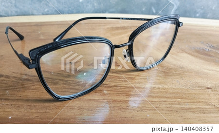 Black Frame Eyeglasses on Wooden Table Close Up Black Frame Eyeglasses on Wooden Table Close Up 140408357