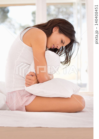 Woman, stomachache and period pain on bed, cramps and appendicitis in home for discomfort. Female person, pillow and constipation or ulcer in bedroom, muscle strain and bloating or menstrual crisis Woman, stomachache and period pain on bed, cramps and appendicitis in home for discomfort. Female person, pillow and constipation or ulcer in bedroom, muscle strain and bloating or menstrual crisis 140408451