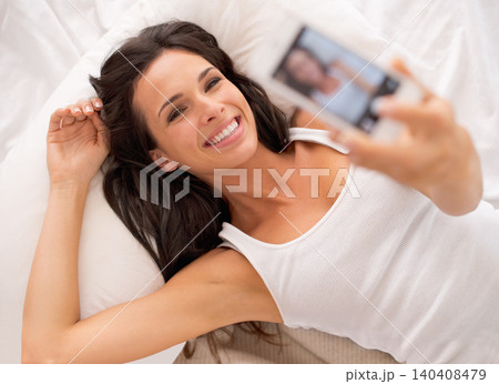 Woman, selfie and above in bedroom with smile on vacation, hotel or relax for photography on web blog. Girl, person and influencer for profile picture, home and live streaming in bed on social media Woman, selfie and above in bedroom with smile on vacation, hotel or relax for photography on web blog. Girl, person and influencer for profile picture, home and live streaming in bed on social media 140408479