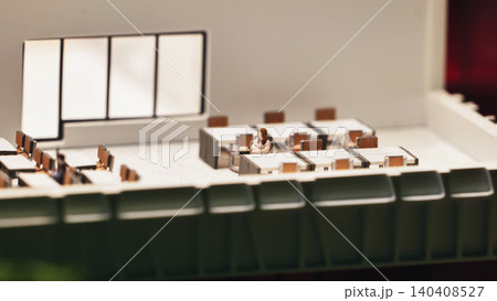 Miniature office diorama with a lonely woman figure representing solitude in the workplace Miniature office diorama with a lonely woman figure representing solitude in the workplace 140408527