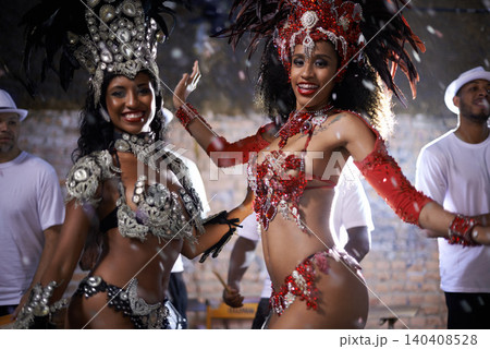 Samba, portrait and performance of women in Rio de Janeiro, smile and dancing for crowd with energy. Female people, artistic and clothes from feather for fashion with culture, music and celebration Samba, portrait and performance of women in Rio de Janeiro, smile and dancing for crowd with energy. Female people, artistic and clothes from feather for fashion with culture, music and celebration 140408528