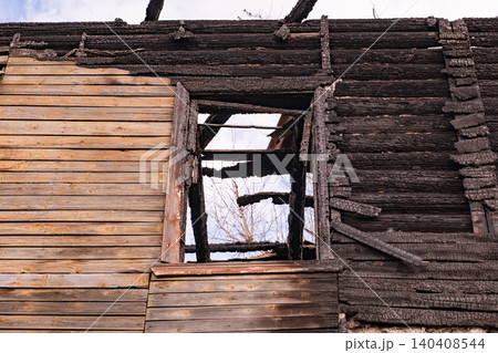 Burnt house structure showing extensive fire damage and destructive aftermath Burnt house structure showing extensive fire damage and destructive aftermath 140408544