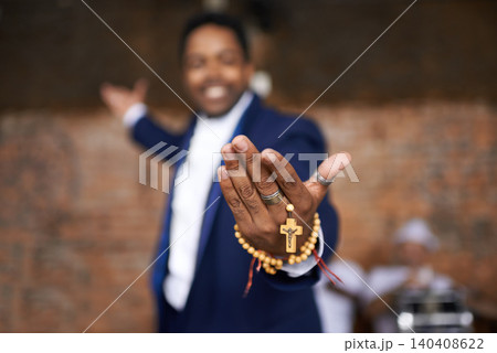 Black man, christianity and hands with cross at church for holy welcome, faith or hope of spiritual leader. Closeup of African male person, priest or preacher with rosary beads for worship of god Black man, christianity and hands with cross at church for holy welcome, faith or hope of spiritual leader. Closeup of African male person, priest or preacher with rosary beads for worship of god 140408622