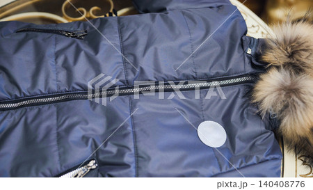 Quilted winter jacket featuring blue fabric, zipper, and faux fur hood Quilted winter jacket featuring blue fabric, zipper, and faux fur hood 140408776