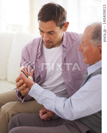 Elderly, man and son or medal on sofa with war badge, pride and honor for military hero in living room of home. Senior, veteran and retired soldier with medallion for service in army with happiness 140409013