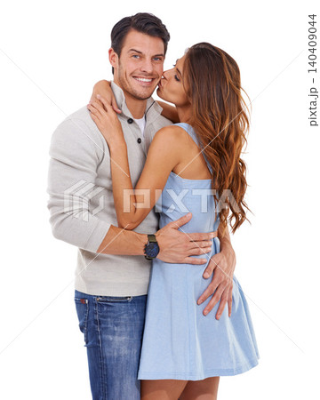 Couple, hug and kiss in studio with happiness for romance, bonding or honeymoon date with affection. Marriage, man and woman with embrace, care or smile for anniversary commitment on white background 140409044