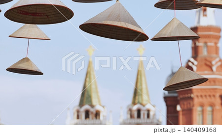 Vietnamese conical hats hanging with Moscow Kremlin in background 140409168