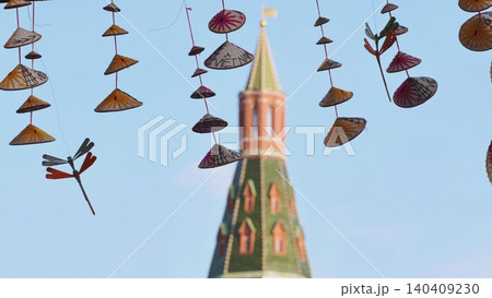 Vietnamese conical hats hanging with Moscow Kremlin tower in background Vietnamese conical hats hanging with Moscow Kremlin tower in background 140409230
