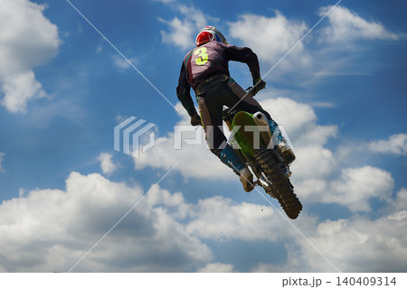 A motorcyclist jumping A motorcyclist jumping 140409314