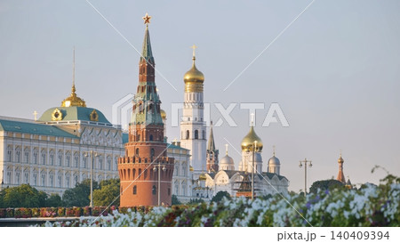 Moscow Kremlin architecture and golden domes rising above flowering plants 140409394
