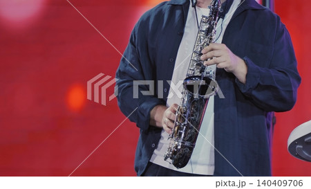 Musician playing an alto saxophone during a live jazz or blues music concert 140409706