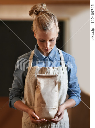 Woman, barista and paper bag with apron in coffee shop, small business owner with parcel and serious for service. Catering, hospitality and entrepreneur with eco friendly package for product in store Woman, barista and paper bag with apron in coffee shop, small business owner with parcel and serious for service. Catering, hospitality and entrepreneur with eco friendly package for product in store 140409746