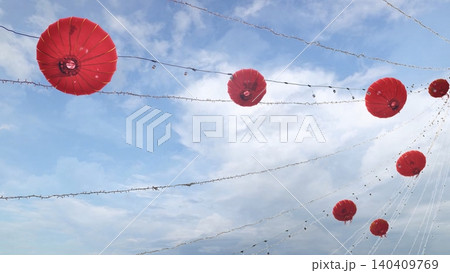 Red lanterns decorating street for Chinese New Year celebration, blue sky background Red lanterns decorating street for Chinese New Year celebration, blue sky background 140409769