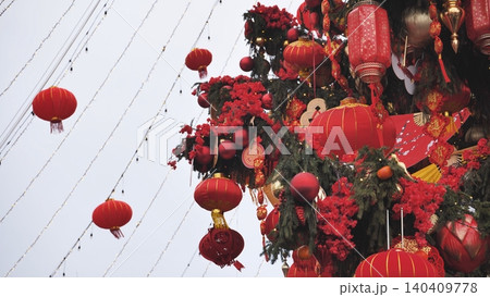 Chinese New Year decorations featuring hanging red lanterns and festive ornaments 140409778