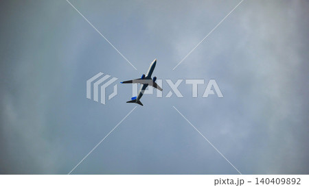 Passenger airplane flying high in the blue sky leaving contrails Passenger airplane flying high in the blue sky leaving contrails 140409892