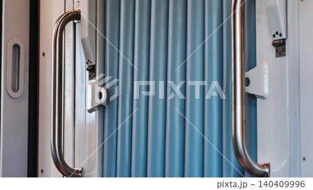 Moscow metro train interior with accordion connector and grab handles 140409996
