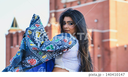 Bangladeshi woman posing in Moscow with a colorful scarf and blurred Kremlin background Bangladeshi woman posing in Moscow with a colorful scarf and blurred Kremlin background 140410147