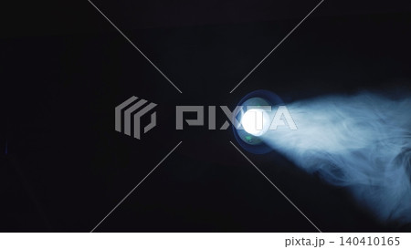 Projector light beam projecting through smoke in a dark room Projector light beam projecting through smoke in a dark room 140410165