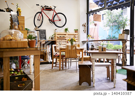 Interior, bike on wall of empty coffee shop with tables and chairs for retail, service or hospitality. Space, small business or startup restaurant with cafeteria seating for bistro consumerism Interior, bike on wall of empty coffee shop with tables and chairs for retail, service or hospitality. Space, small business or startup restaurant with cafeteria seating for bistro consumerism 140410387