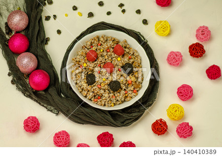 Bowl with modern kutia and spices. Christmas dessert Kutia on a modern table. Christmas modern sweet meal in Ukraine. Bowl with modern kutia and spices. Christmas dessert Kutia on a modern table. Christmas modern sweet meal in Ukraine. 140410389