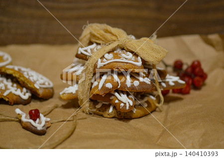 Royal icing cookies. Christmas gingerbread cookies on wooden table top view. Flat lay of Christmas gingerbread cookies on wooden background. Sprinkle accents introduce vibrant contrast. Royal icing cookies. Christmas gingerbread cookies on wooden table top view. Flat lay of Christmas gingerbread cookies on wooden background. Sprinkle accents introduce vibrant contrast. 140410393