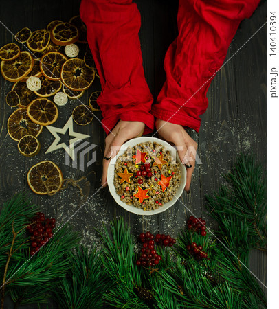 Multiple hands hold Christmas porridge kutyal, symbolizing family gathering and communal holiday meal tradition. Multiple hands hold Christmas porridge kutyal, symbolizing family gathering and communal holiday meal tradition. 140410394
