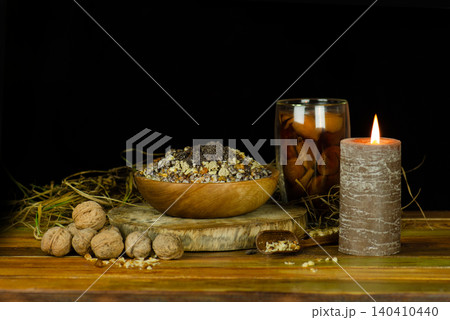 Christmas celebration in Ukraine with compote uzvar with traditional dried fruit and kutya. Christmas kutya made of poppy seed, nuts and honey with compote uzvar traditional dried fruit drink. Christmas celebration in Ukraine with compote uzvar with traditional dried fruit and kutya. Christmas kutya made of poppy seed, nuts and honey with compote uzvar traditional dried fruit drink. 140410440