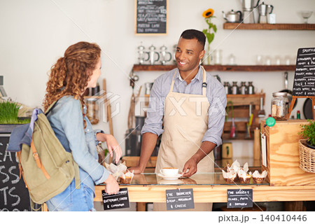 Barista, cafe and customer service with order, drink and talking with smile for support or hospitality at counter. Small business owner or waiter with latte, student and sale at coffee shop or bakery Barista, cafe and customer service with order, drink and talking with smile for support or hospitality at counter. Small business owner or waiter with latte, student and sale at coffee shop or bakery 140410446