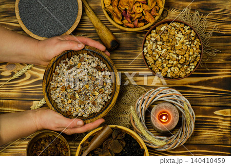 Cultural holiday food concept representing Ukrainian Christmas culinary tradition. Traditional Ukrainian Christmas kutya with ingredients and candle. Cultural holiday food concept representing Ukrainian Christmas culinary tradition. Traditional Ukrainian Christmas kutya with ingredients and candle. 140410459