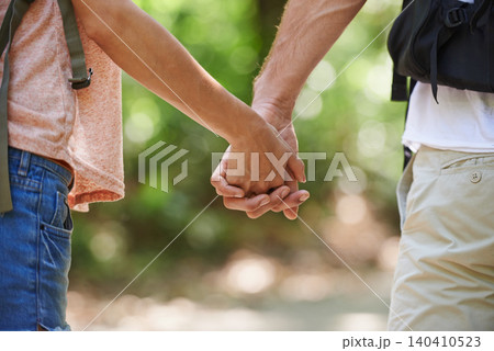 Couple, holding hands and support with love in nature for bonding, walk or hiking adventure together. Closeup of man and woman in unity, trust or teamwork for trekking in outdoor woods or forest Couple, holding hands and support with love in nature for bonding, walk or hiking adventure together. Closeup of man and woman in unity, trust or teamwork for trekking in outdoor woods or forest 140410523