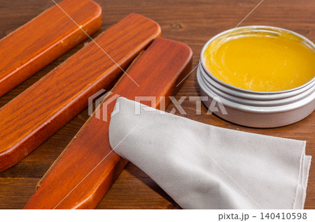 Applying beeswax to a wooden surface. Applying beeswax to a wooden surface. 140410598