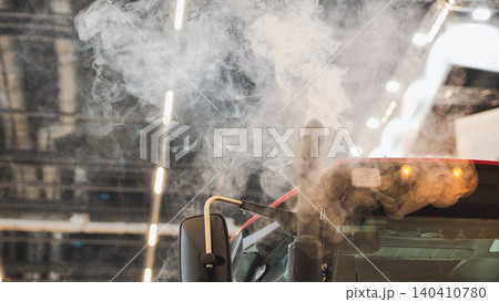 Truck emitting exhaust smoke causing air pollution and environmental impact Truck emitting exhaust smoke causing air pollution and environmental impact 140410780