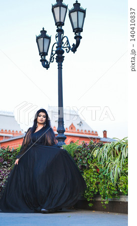 Bangladeshi woman posing in elegant black dress next to antique street lamp in Moscow Bangladeshi woman posing in elegant black dress next to antique street lamp in Moscow 140410837